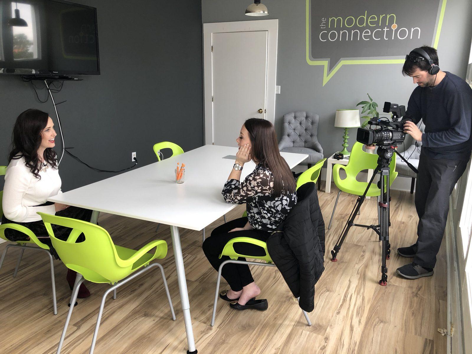 Ashley Thiesen being interviewed for a local TV segment on social media at The Modern Connection office in Charleston