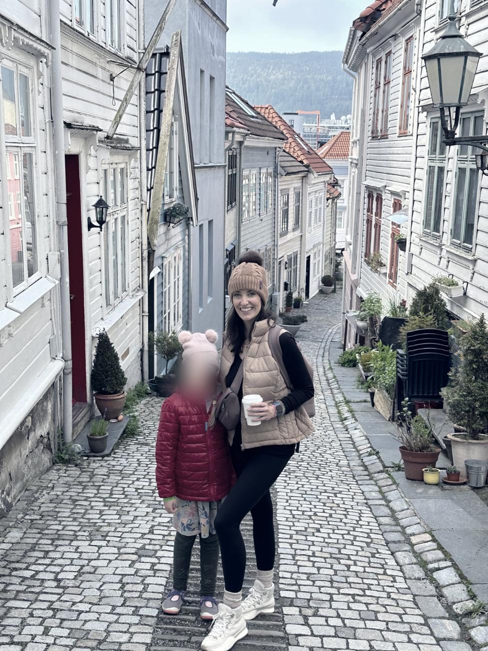 Ashley and her daughter on a cobbled lane in Bergen, Norway