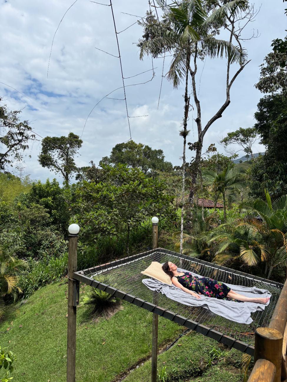 Ashley resting in a hammock overlooking the jungle in Colombia