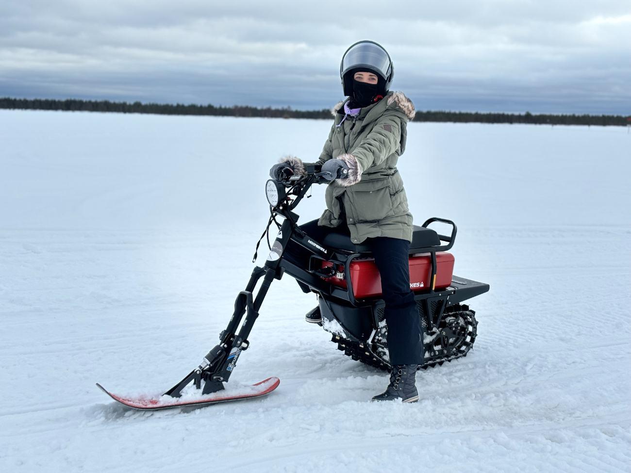 Ashley on a moonbike on a frozen lake in Finland