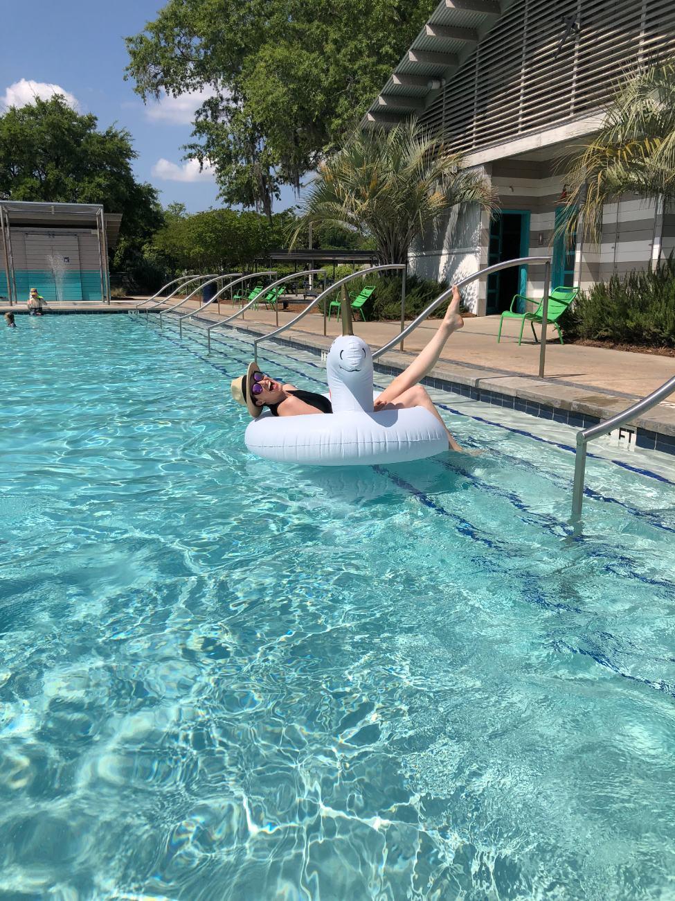 Ashley laughing on a swan pool float
