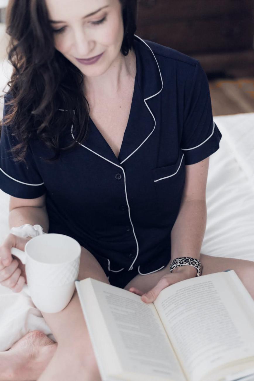 A cup of coffee held over an open book