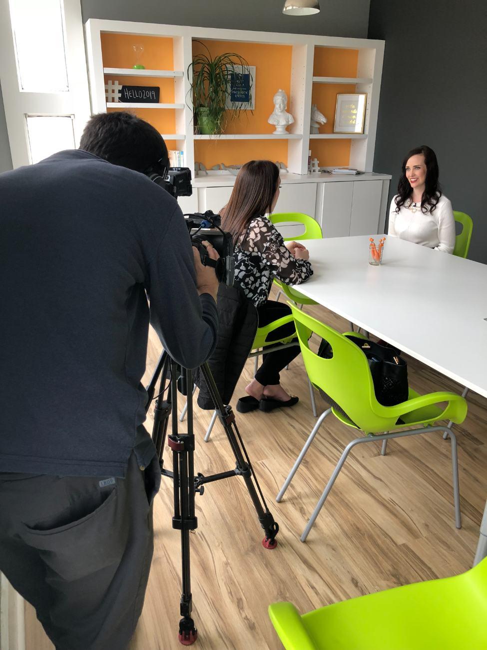 Ashley Thiesen being interviewed on camera at The Modern Connection